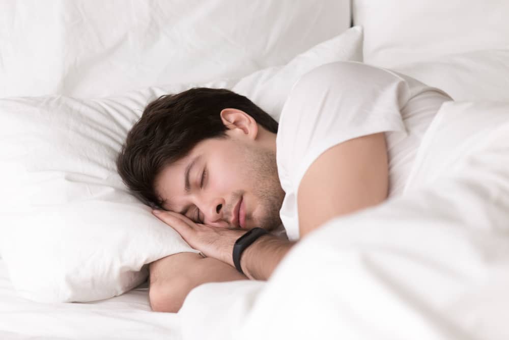 young guy sleeping bed wearing smartwatch sleep tracker 1 | فروشگاه کاکو رضا
